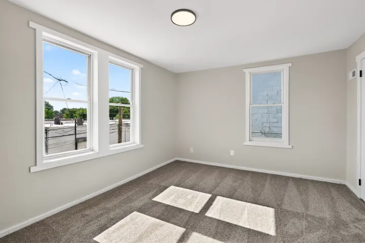 Bedroom with sunlit carpet